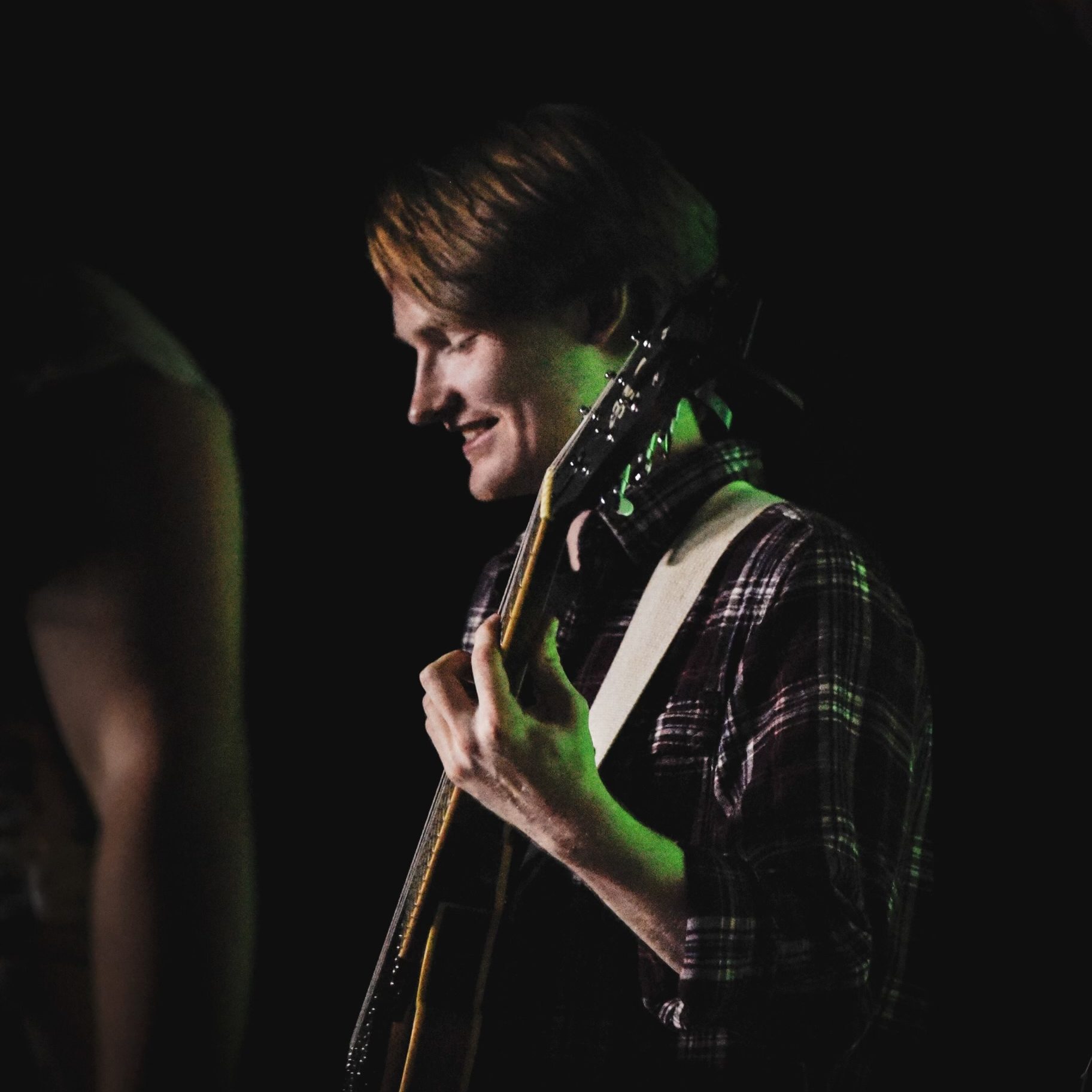 A picture of Joshua Duvall playing guitar.